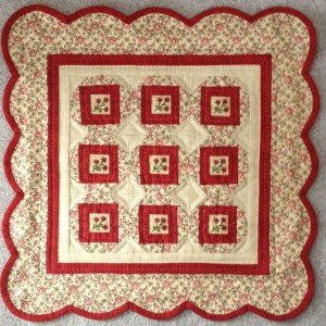 Little Red Ten is 16" x 16" and has those cute little red flower buttons in the center of each block. The buttons are included in the pattern. The kit includes the fabrics for the top, back, and binding along with the pattern